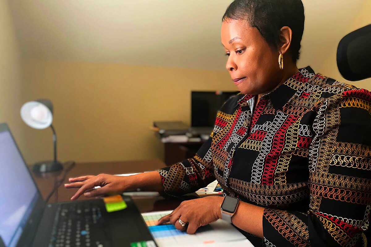 Woman works on laptop.