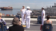 Rear Adm. Roy Kitchener, Commander, Naval Surface Force Atlantic (SURFLANT), center, salutes Adm. Christopher W. Grady, Commander, United States Fleet Forces, left, during the SURFLANT change of command ceremony aboard the San Antonio-class amphibious transport dock ship USS Arlington (LPD 24).
