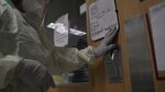 A provider enters a patient room in a COVID-19 intensive care unit at Brooke Army Medical Center, July 17, 2020.