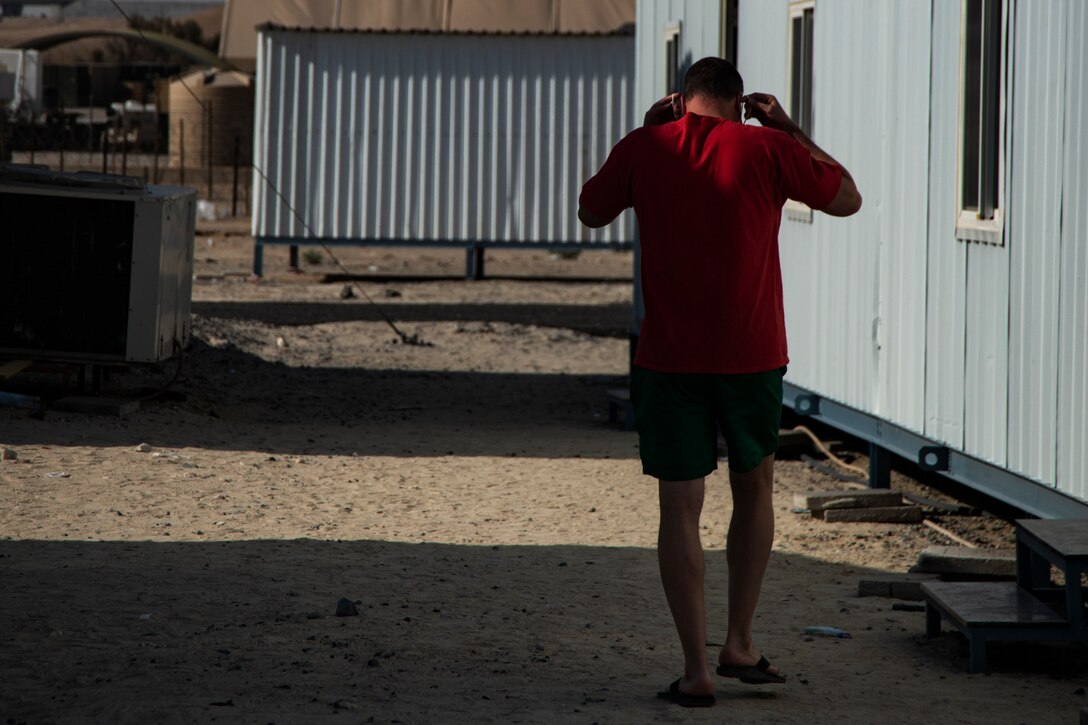 People wearing masks at Ali Al Salem Kuwait working and being served by Airmen.