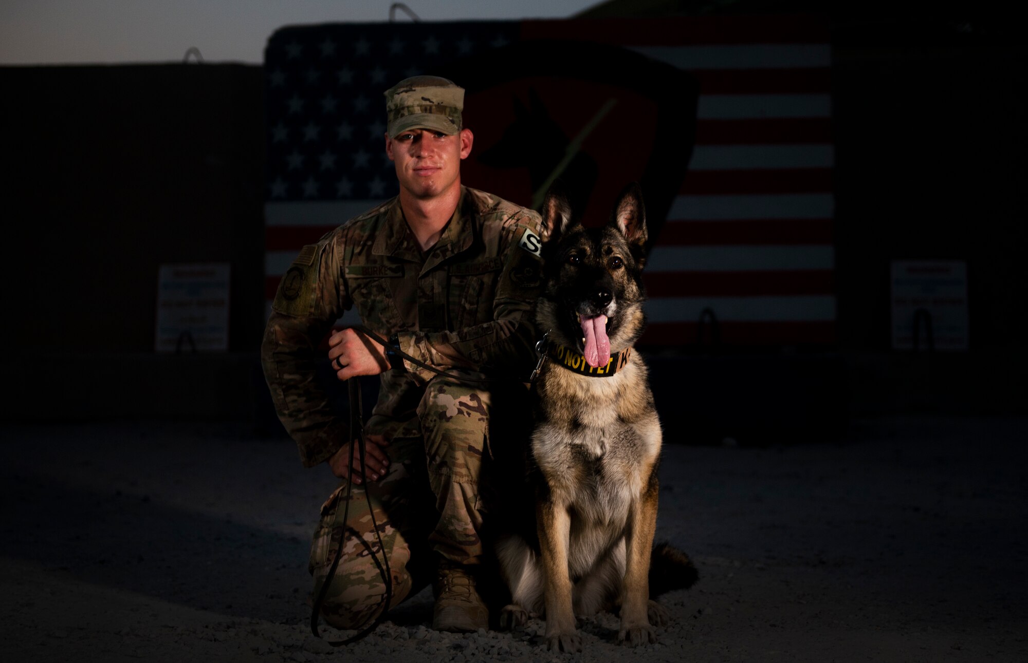 Staff Sgt. Joseph Burke, 368th Expeditionary Security Forces Squadron military working dog handler, rewards Ricki, 386th ESFS MWD, for being a good boy at Ali Al Salem Air Base, Kuwait, July 26, 2020.