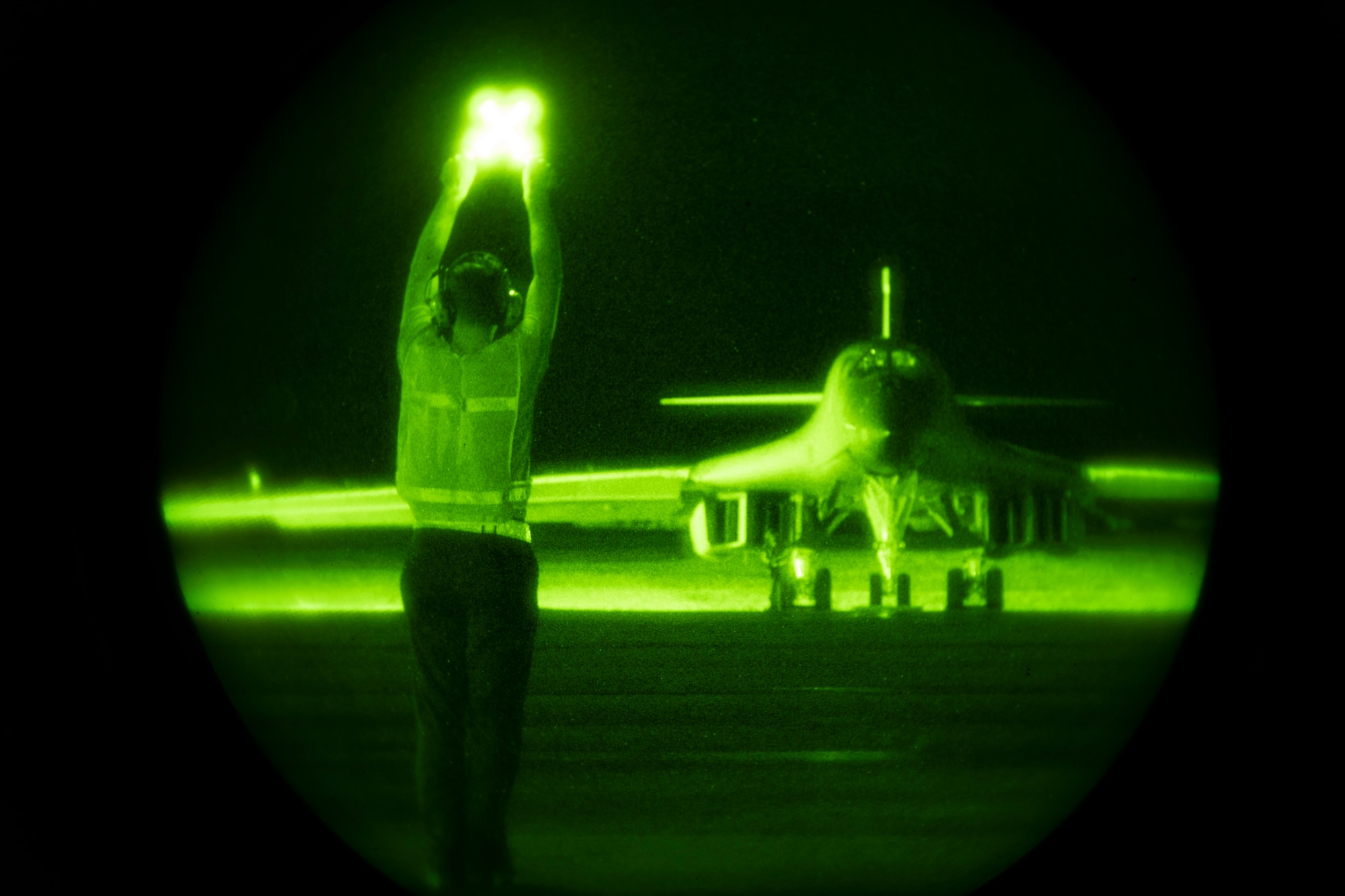A crew chief, assigned to the 28th Aircraft Maintenance Squadron, 37th Aircraft Maintenance Unit, guides a B-1B Lancer onto the taxiway, ahead of a Bomber Task Force mission to the South China Sea from Andersen Air Force Base, Guam, July 27, 2020. Bomber Task Force missions familiarize aircrews with air bases, procedures and operations in different geographic combatant command’s areas of operations. (U.S. Air Force Photo by Airman 1st Class Christina Bennett)