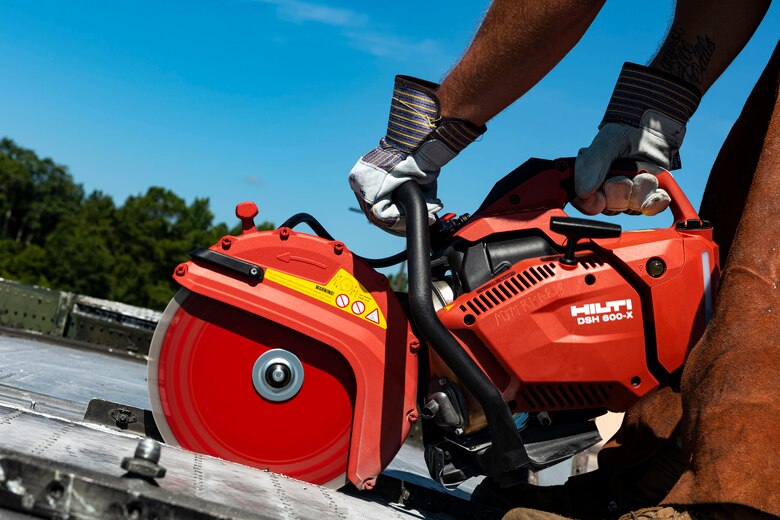 Photo of an Airman cutting into an HC-130J.
