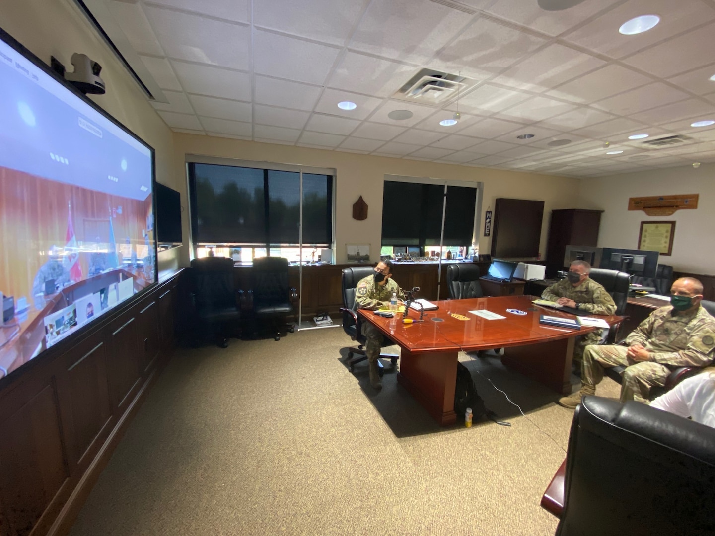West Virginia National Guard Adjutant General, Maj. Gen. James Hoyer, alongside the Senior Enlisted Leader, Command Sgt. Maj. Phillip Cantrell, participate in a video teleconference with the Peruvian Air Force (Fuerza Aérea del Perú (FAP)) commanding general, Rodolfo Garcia and staff July 21, 2020, from the WVNG Joint Forces Headquarters in Charleston, West Virginia. The purpose of this senior officer meeting was to share information, best practices and lessons learned on military response efforts to the current COVID-19 pandemic, as well as discuss plans for potential future engagements. (U.S. Army National Guard photo by Maj. Joshua Poling)
