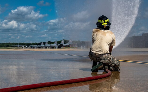 Firefighters assigned to the 910th Fire Department discuss training procedures, July 24, 2020, on the flightline at Youngstown Air Reserve Station. Airmen from the FD were completing Seasonal Training requirements for pump operations. ST is a program where Airmen raise their skill level from apprentice to a journeyman.