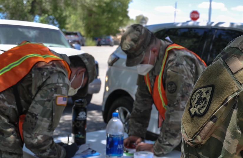 Nevada National Guardsmen review patient records at a drive-thru COVID-19 test site.