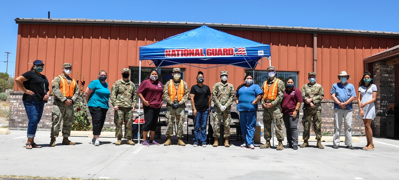Nevada National Guardsmen pose for a  photo with members from the Duckwater Shoshone Health Department.
