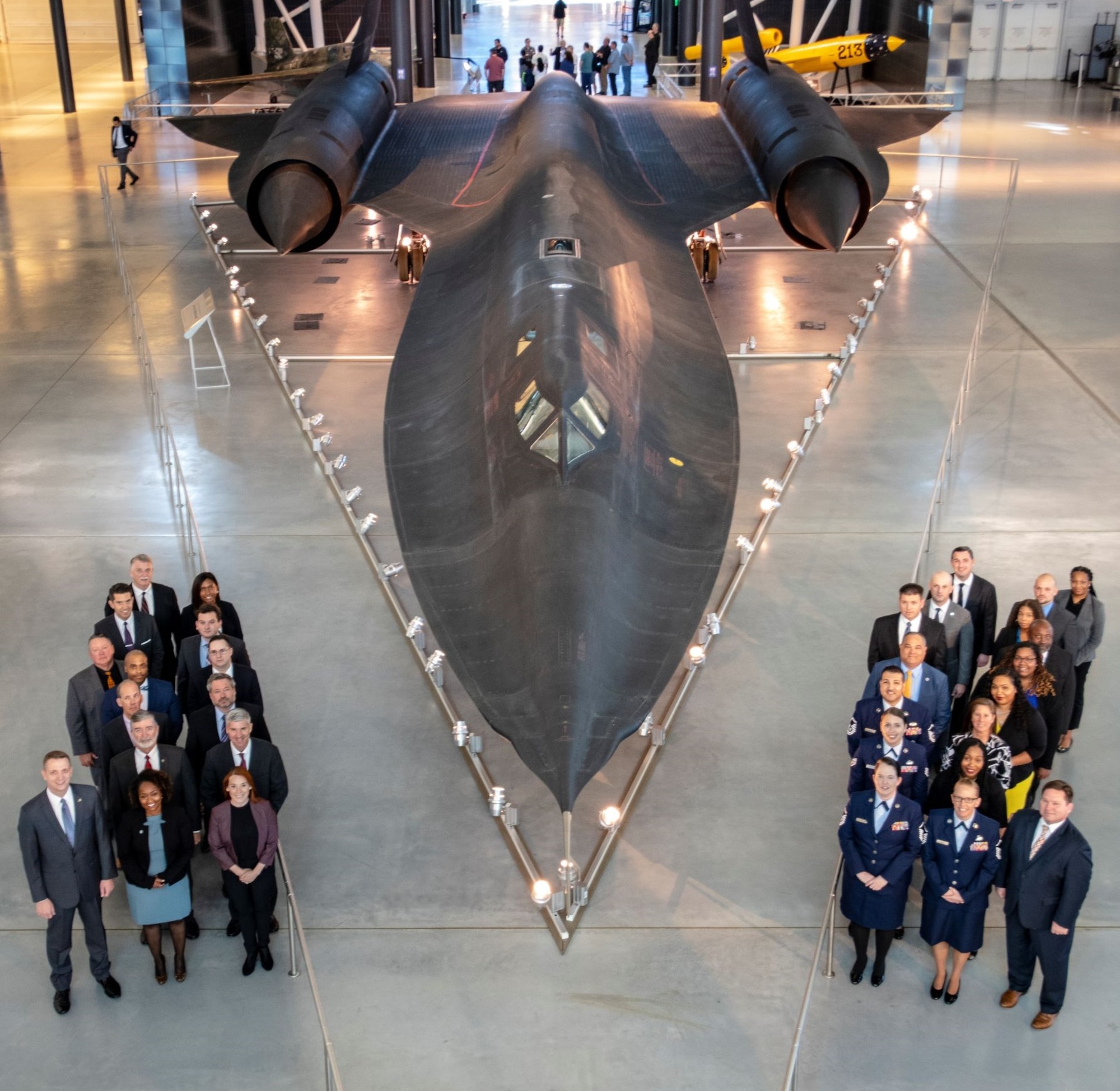 Mr. Terry Phillips, lower right front row, the Executive Director, OSI Office of Special Projects (PJ) and United States Air Force and Space Force Special Access Program Security Director, is joined by fellow PJ members framing a displayed SR-71 Blackbird reconnaissance aircraft. (PJ courtesy photo)