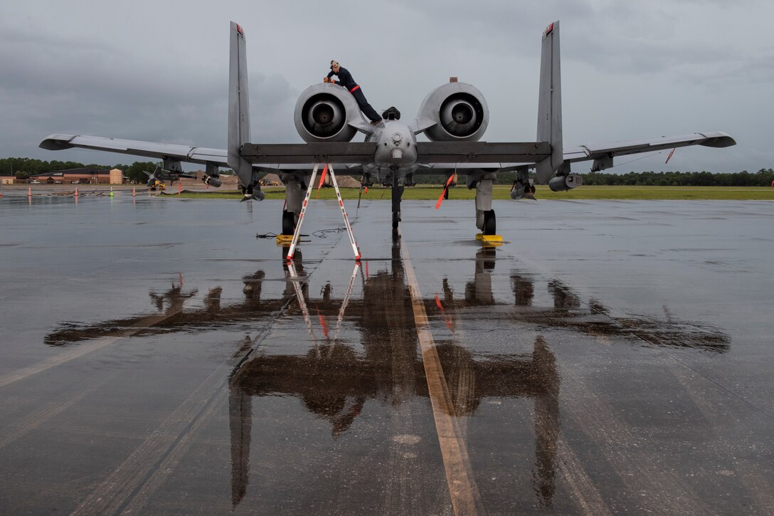 A photo of an Airman maintaining an aircraft