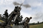 Soldiers with the Michigan Army National Guard's B Battery, 1st Battalion, 119th Field Artillery Regiment execute a direct fire mission during exercise Northern Strike at Camp Grayling, Michigan, July 26, 2020.