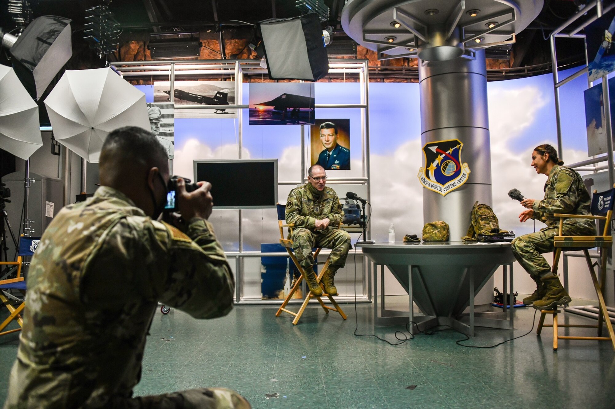 U.S. Air Force Staff Sgt. Randy Duffy, 61st Civil Engineering & Logistics Squadron, NCOIC of Construction Management and serving as NCOIC of SMC Public Affairs, takes a photo of Senior Enlisted Advisor of the United States Space Force, Chief Master Sgt. Roger Towberman during his Blue Grit Podcast interview with Maj. Anna Fedotova, base psychologist at Los Angeles AFB, July 15, 2020. Staff Sgt. Duffy is part of the Enlisted Developmental Duty Position program, which is a 61st Air Base Group initiative that grants the opportunity for enlisted Airmen to gain experience outside of their normal career field and duties, while supporting the overall Space and Missile Systems Center (SMC) mission.  (U.S. Air Force photo by Van De Ha)