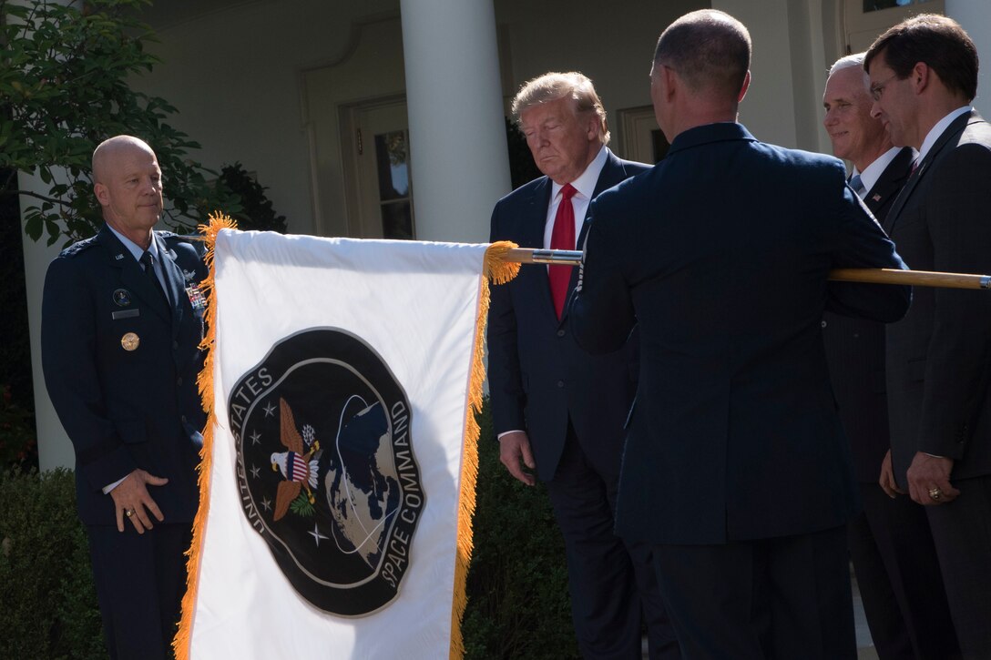 Men unfurl command flag.