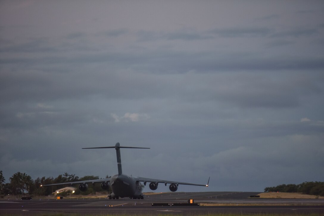 A 60th Air Mobility Wing C-17 from Travis Air Force Base, California, taxis from the Hickam Field flight line July 17, 2020, at Joint Base Pearl Harbor-Hickam, Hawaii. A team of Airmen from several commands rapidly executed a Transport Isolation System in support of a COVID-19 bio-containment aeromedical evacuation mission. This is the first time the TIS was utilized in the Indo-Pacific area of operations. The TIS is an infectious disease containment unit designed to minimize contamination risk to aircrew and medical attendants, while allowing in-flight medical care for patients afflicted by a disease. (U.S. Air Force photo by Tech. Sgt. Anthony Nelson Jr.)