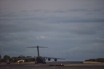 A 60th Air Mobility Wing C-17 from Travis Air Force Base, California, taxis from the Hickam Field flight line July 17, 2020, at Joint Base Pearl Harbor-Hickam, Hawaii. A team of Airmen from several commands rapidly executed a Transport Isolation System in support of a COVID-19 bio-containment aeromedical evacuation mission. This is the first time the TIS was utilized in the Indo-Pacific area of operations. The TIS is an infectious disease containment unit designed to minimize contamination risk to aircrew and medical attendants, while allowing in-flight medical care for patients afflicted by a disease. (U.S. Air Force photo by Tech. Sgt. Anthony Nelson Jr.)