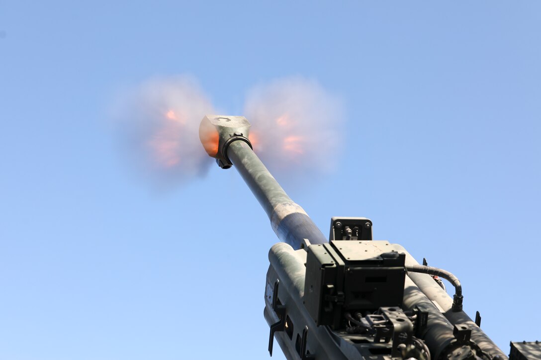 A blast is seen as a round fires from a howitzer