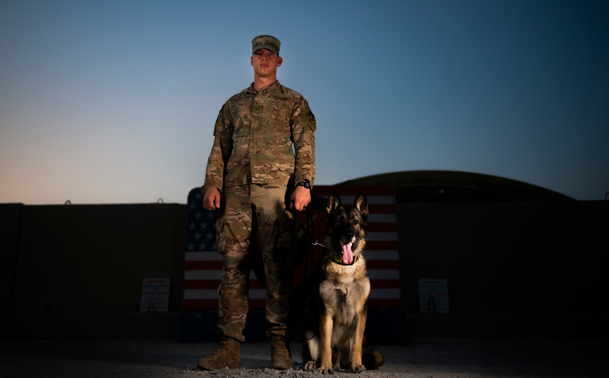 Staff Sgt. Joseph Burke, 368th Expeditionary Security Forces Squadron military working dog handler, rewards Ricki, 386th ESFS MWD, for being a good boy at Ali Al Salem Air Base, Kuwait, July 26, 2020.