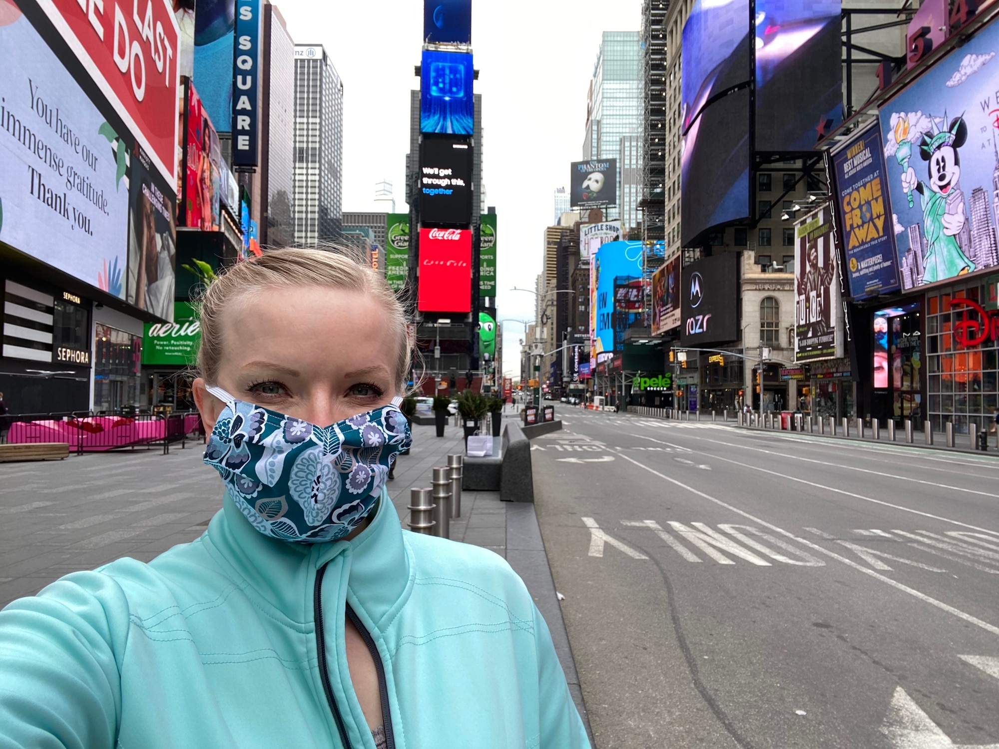 Capt. Melinda McClendon takes a selfie with Times Square behind her. There are no people or traffic on Times Square.