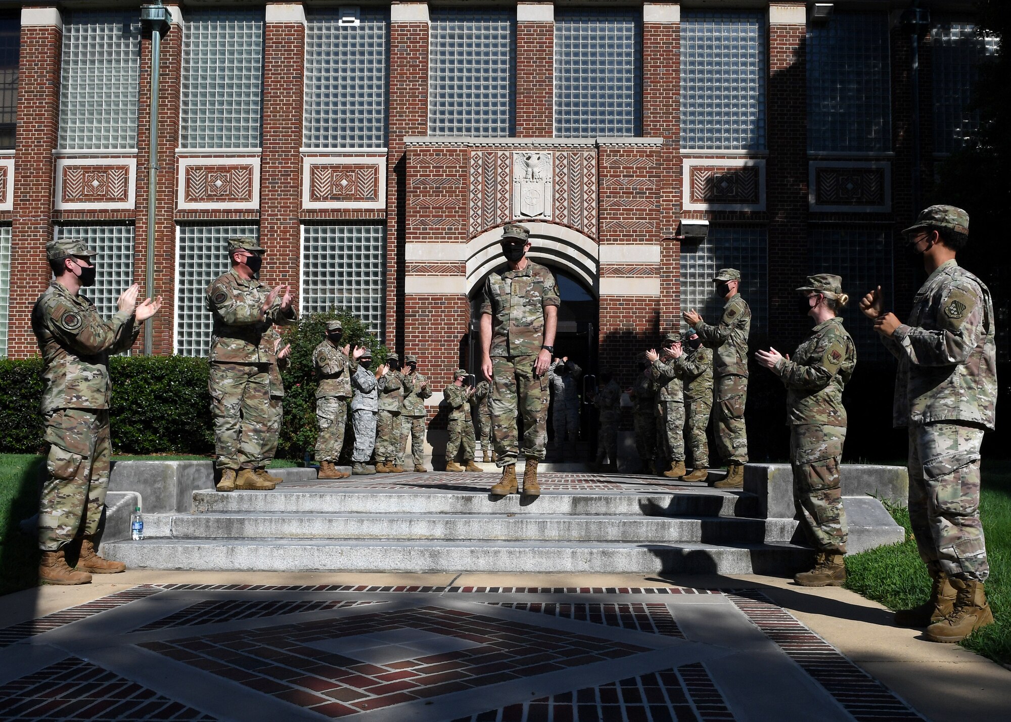 General Holmes is greeted by Airmen at the door