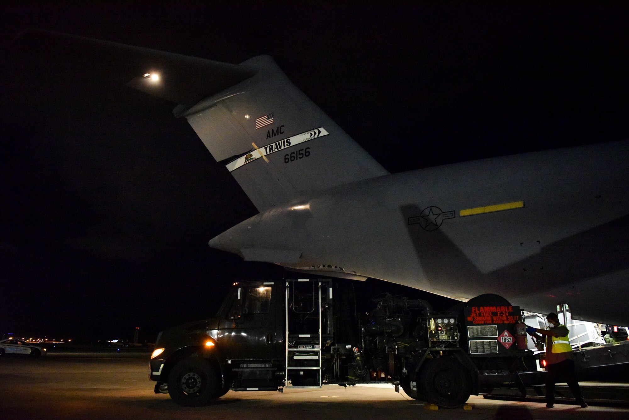 A 60th Air Mobility Wing C-17 from Travis Air Force Base, California, receives fuel on the Hickam Field flight line July 17, 2020, at Joint Base Pearl Harbor-Hickam, Hawaii. A team of Airmen from several commands rapidly executed a Transport Isolation System in support of a COVID-19 bio-containment aeromedical evacuation mission. This is the first time the TIS was utilized in the Indo-Pacific area of operations. The TIS is an infectious disease containment unit designed to minimize contamination risk to aircrew and medical attendants, while allowing in-flight medical care for patients afflicted by a disease. (U.S. Air Force photo by Tech. Sgt. Anthony Nelson Jr.)