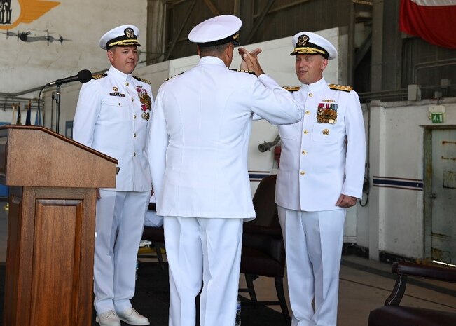 200728-N-UJ449-1189 NAVAL AIR STATION SIGONELLA, Italy (July 28, 2020) Capt. Tim Thompson, center, salutes Vice Adm. Gene Black, commander, U.S. 6th Fleet, signifying his acceptance of command during the commander, Task Force (CTF) 67 change of command ceremony onboard Naval Air Station Sigonella, July 28, 2020. CTF 67 is responsible for command and tactical control of deployed maritime patrol and reconnaissance squadrons throughout the European and African areas of responsibility. (U.S. Navy photo by Mass Communication Specialist 2nd Class Josh Cote)