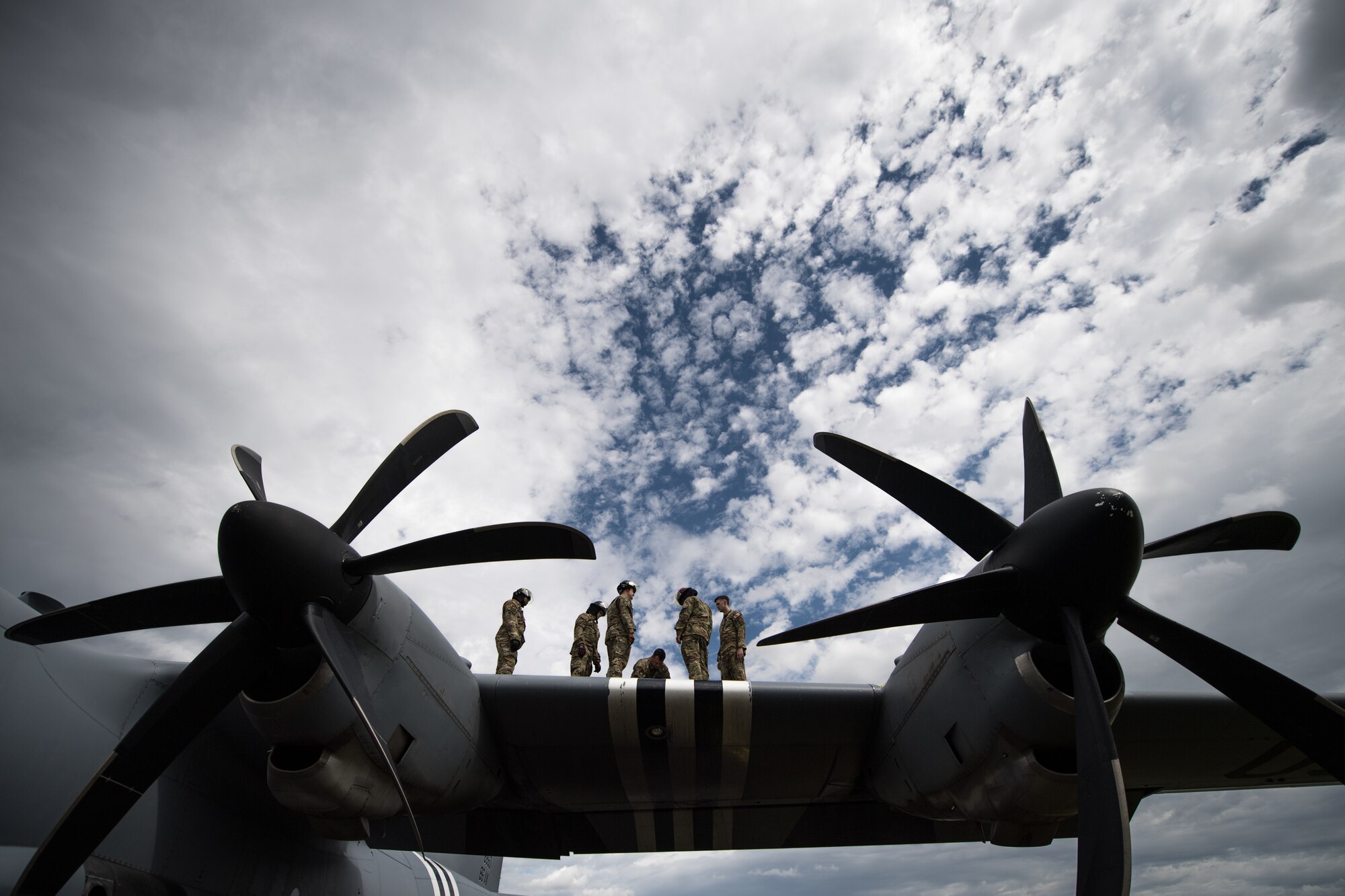 Photo of Airmen standing on aircraft wing