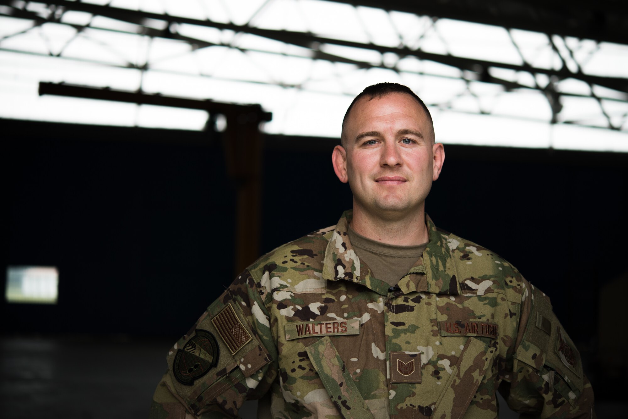 Photo of Airman in uniform posing for a photo