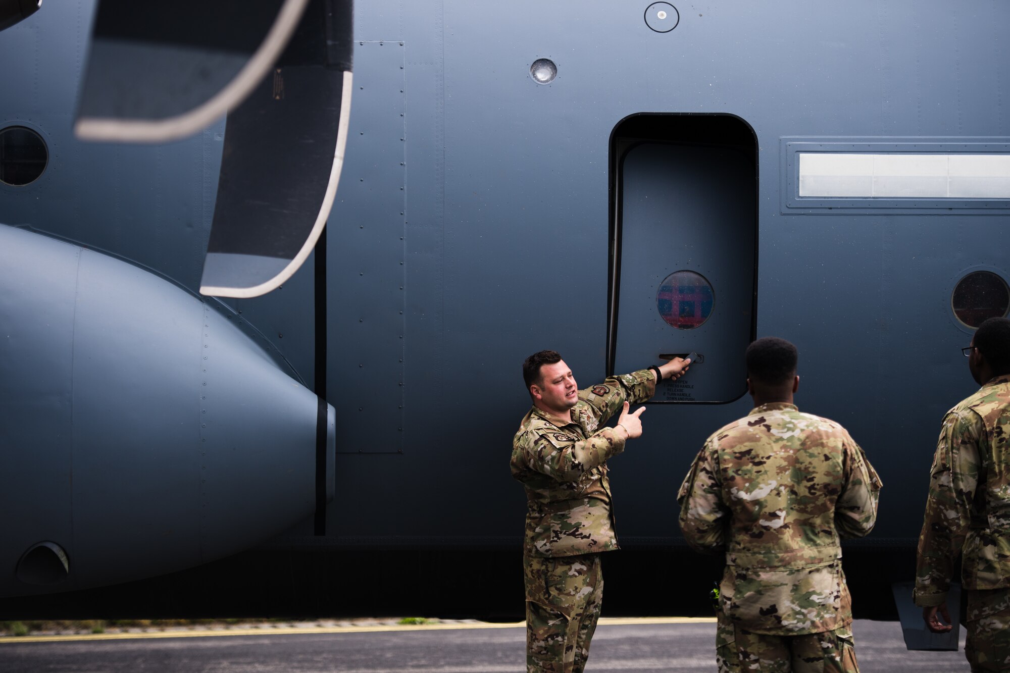Photo of Airman opening aircraft door