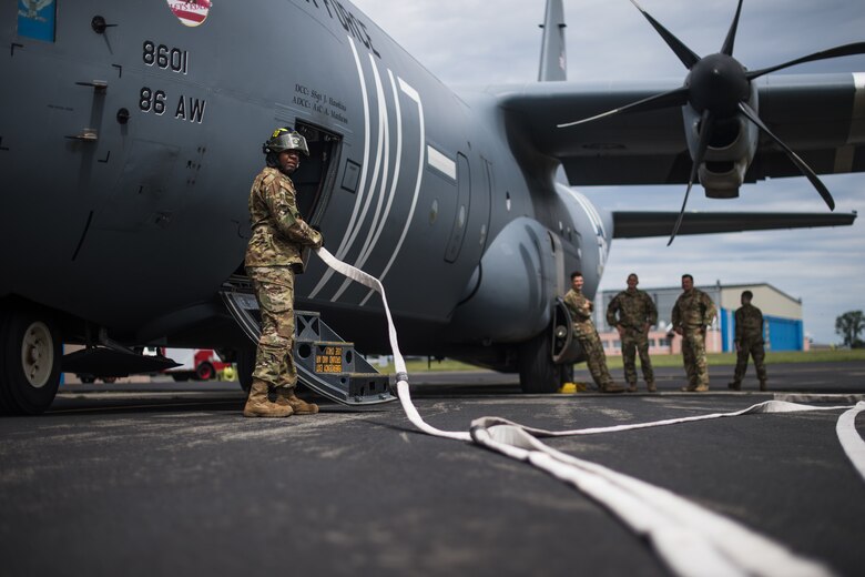 Photo of Air Force firefighter holding hose
