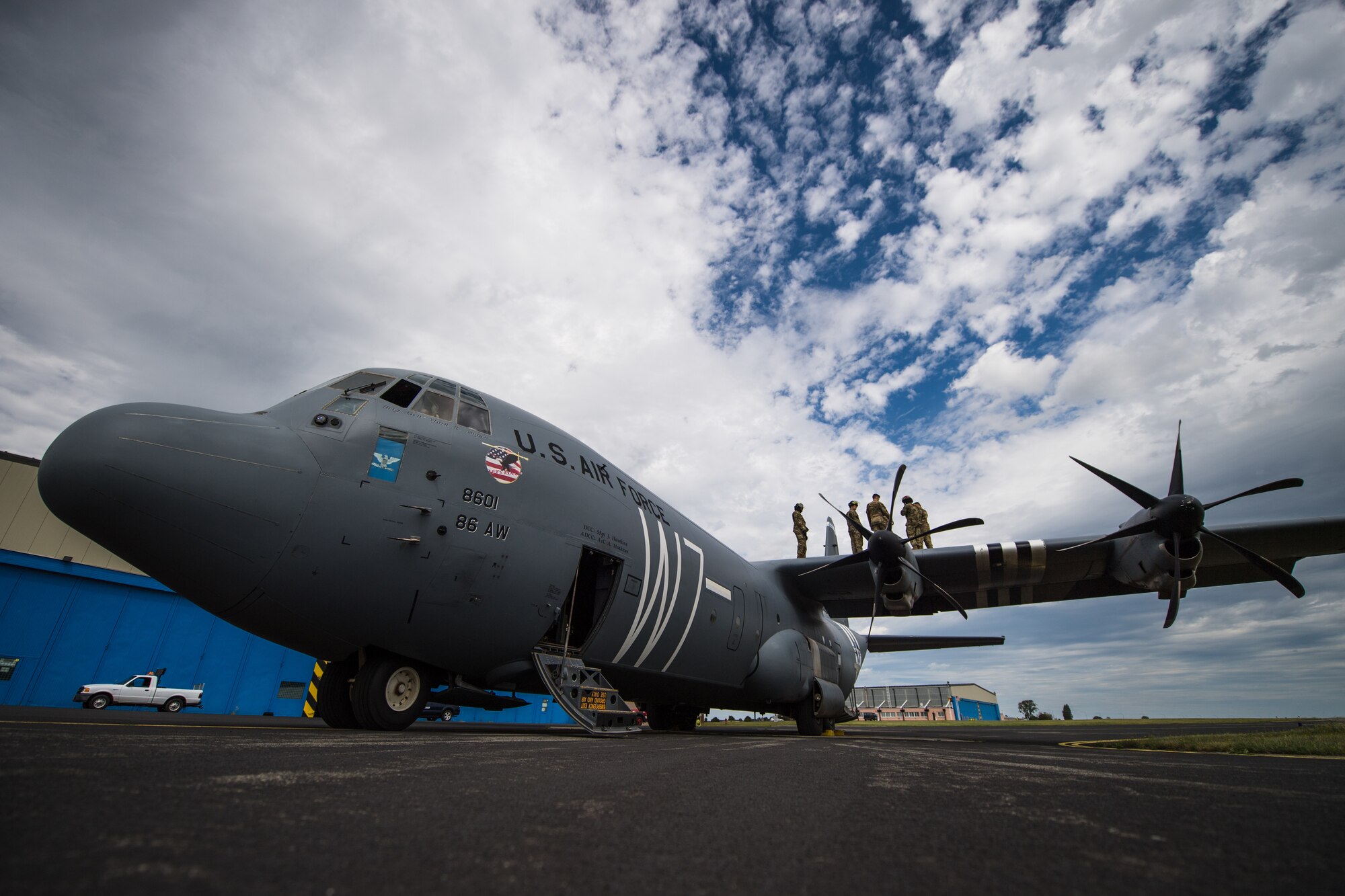 Photo of Airmen on top of aircraft