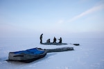 Airmen with the 109th Airlift Wing Skiway construction team employ barren land survival techniques as they erect the first shelter at Camp Rockwell during Air National Guard Exercise Arctic Eagle.