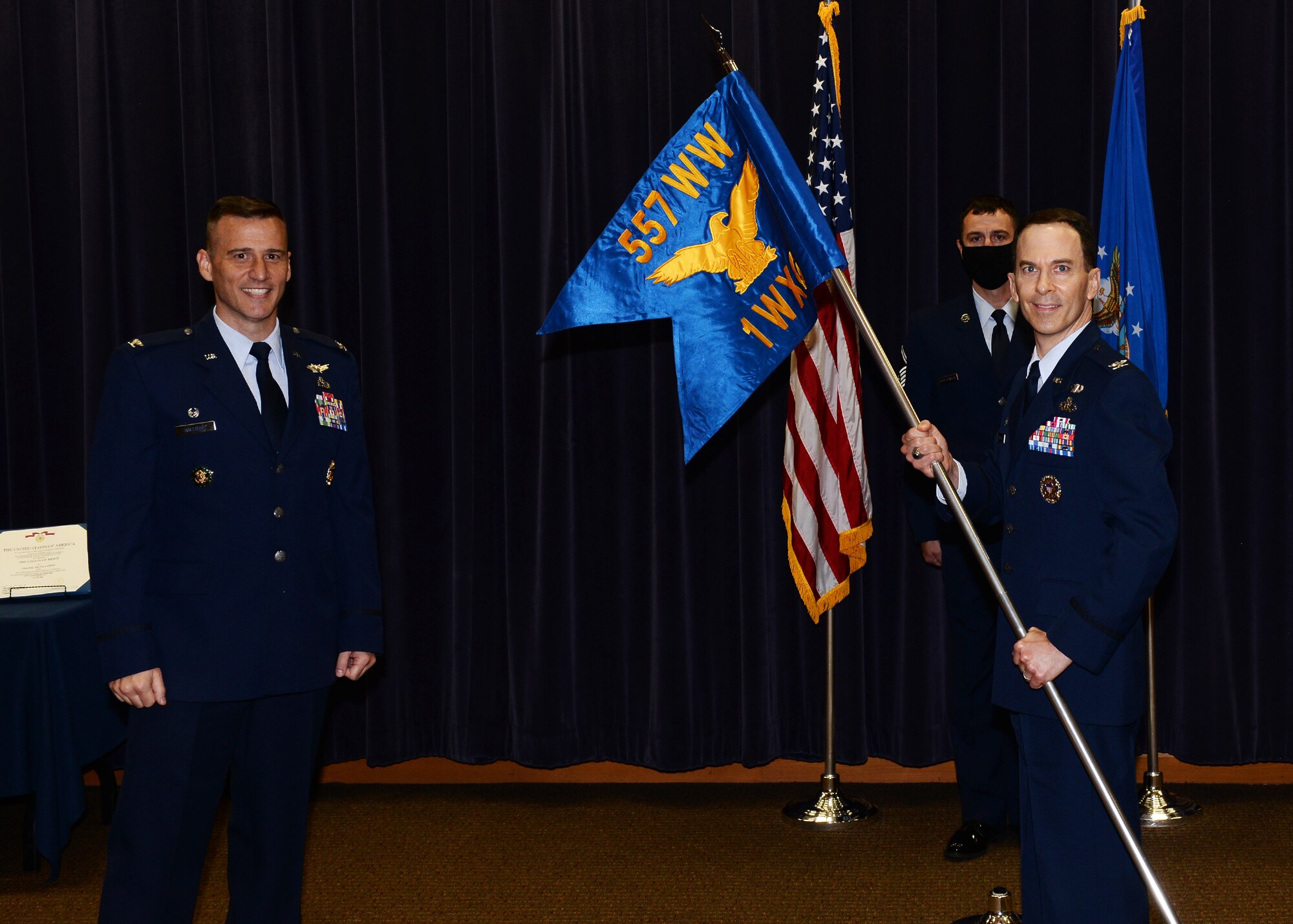 Col. Bradley Stebbins receives the guidon and assumed command of the 1st Weather Group in a socially-distanced ceremony on June 24, 2020 in the Chief Master Sgt. Peter Moore auditorium on Offutt Air Force Base, Nebraska.
