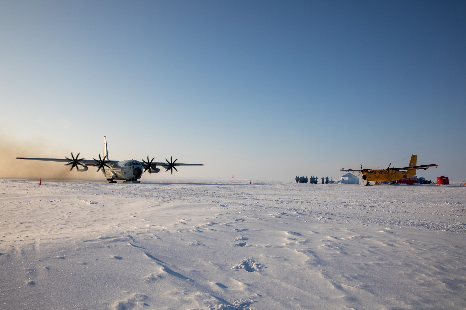 An LC-130 Hercules from the 109th Airlift Wing and a Twin Otter from the Canadian Royal Air Force's 440th Squadron at the remote skiway construction camp during Air National Guard exercise Arctic Eagle, March 1st, 2020.