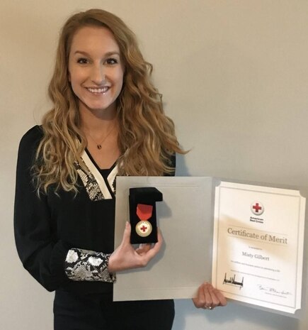 Misty Gilbert, a spouse of U.S. Coast Guard Sector Charleston Boatswain’s mate who works as a nanny, is awarded the Certificate of Merit July 7, 2020, during a virtual recognition ceremony in Summerville, S.C. According to the Red Cross, the Certificate of Merit is the highest award given by the Red Cross to individuals who save or sustain a life using skills learned in a Red Cross Training Services course.