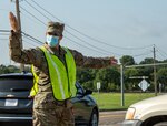 Texas Air National Guard Tech. Sgt. Brenna Jackson directs exiting traffic during a food distribution event on July 8, 2020, in Arlington, Texas.