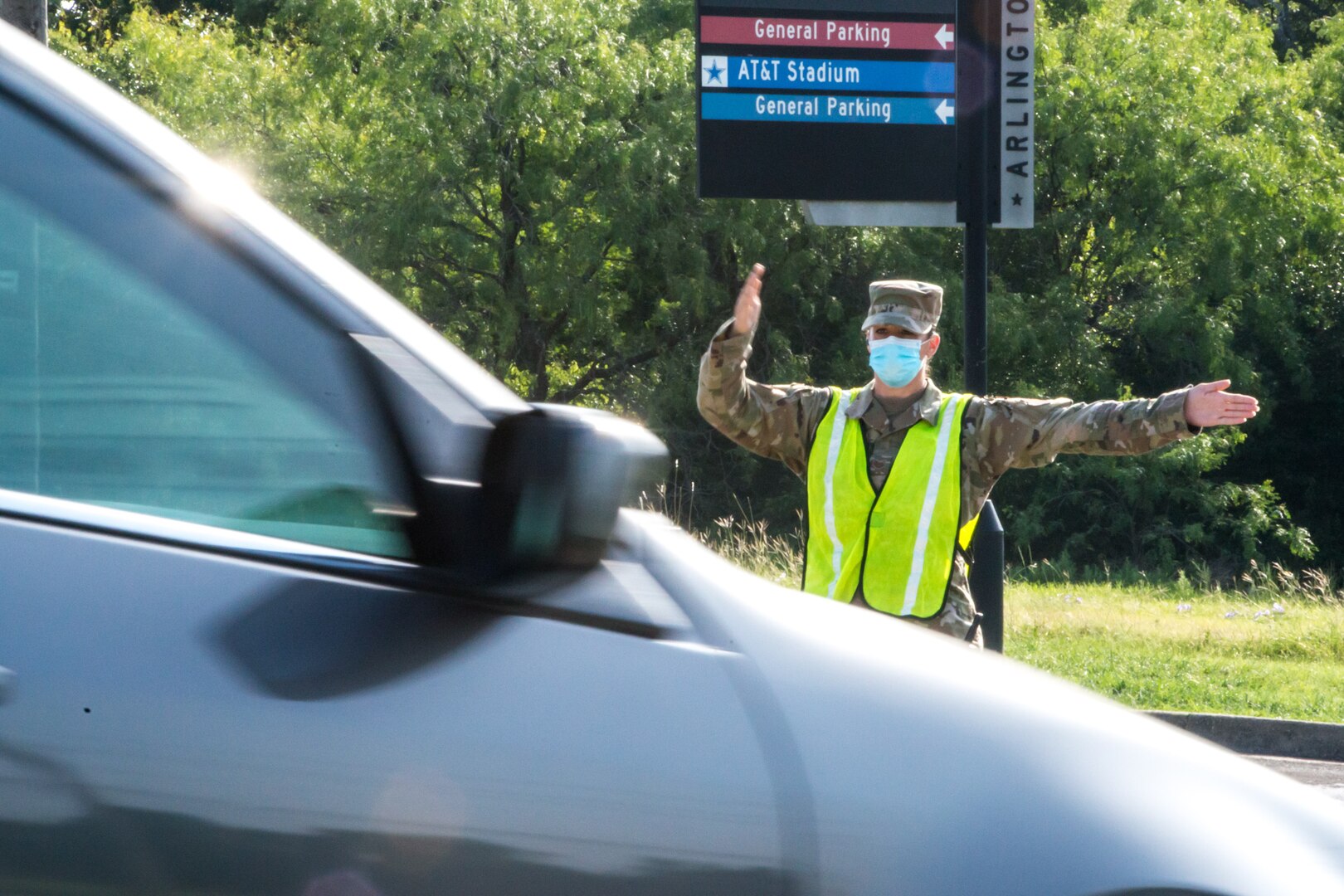 Texas Air National Guard Tech. Sgt. Brenna Jackson directs exiting traffic during a food distribution event on July 8, 2020, in Arlington, Texas.