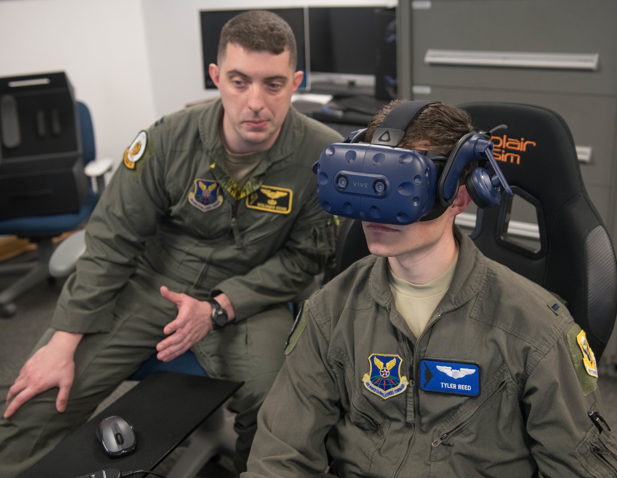 509th Bomb Wing Innovation Director, U.S. Air Force Capt. Benjamin Kram (Left), instructs 13th Bomb Squadron T-38A Trainer Instructor Pilot, U.S. Air Force 1st Lt. Tyler Reed, on how to operate the T-38 Virtual Reality simulator at Whiteman Air Force Base, Missouri, June 24, 2020. VR technology allows pilots to train on specific aircraft to gain exposure and experience. (U.S. Air Force photo by Senior Airman Thomas Johns)