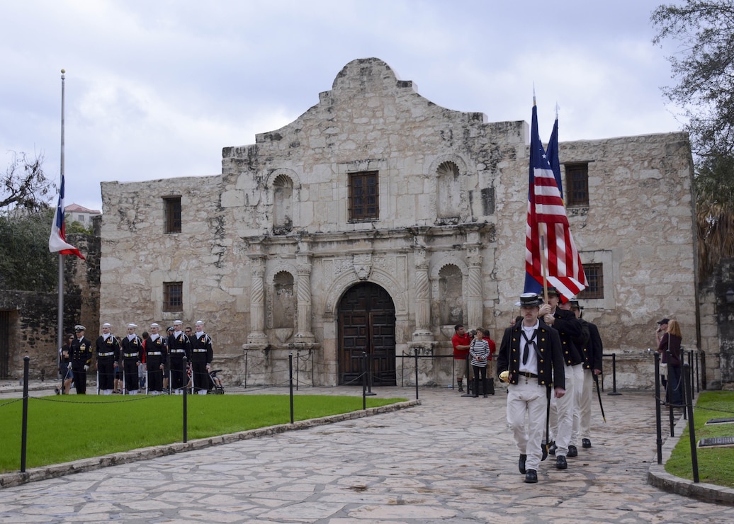 Sailors marching near old building