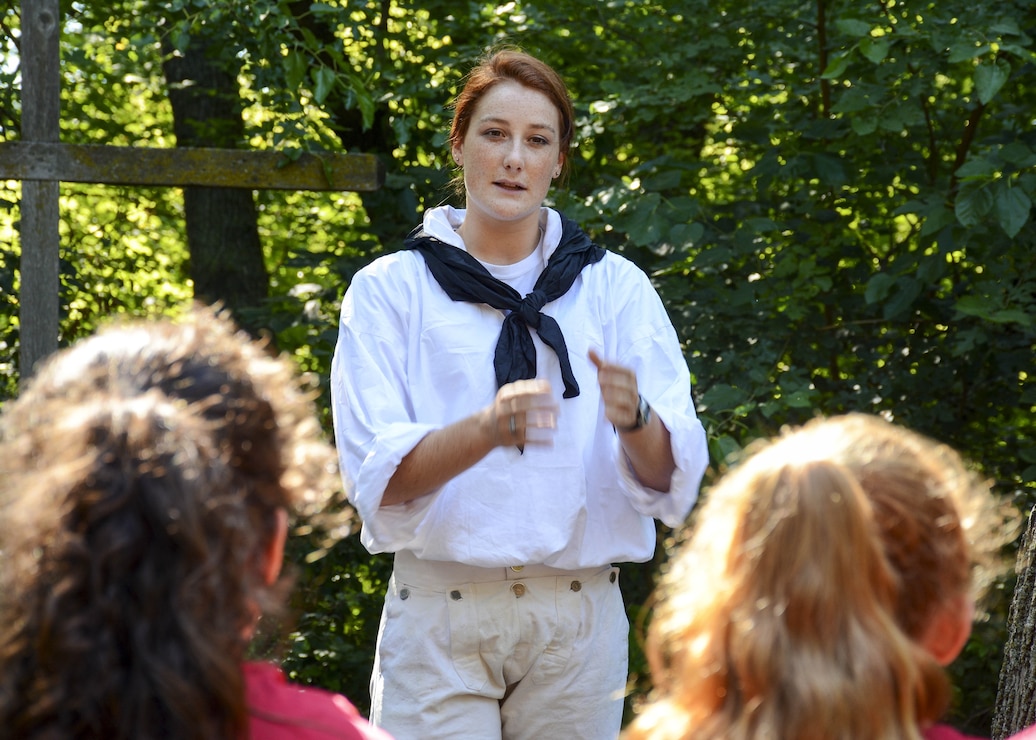 Aubrey Garcia, from Augusta, Calif. and attached to USS Constitution, talks to children at the YMCA's Camp
