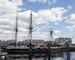 USS Constitution is docked in Charlestown, behind a "thank you". message, written by the crew in wooden letters and signal flags