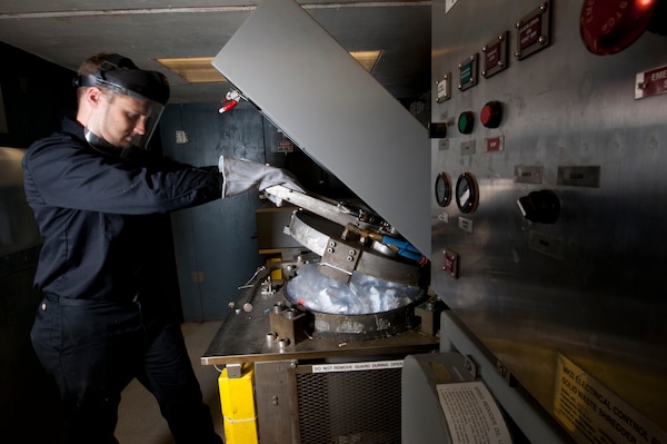 Peter Mech, an engineer at Naval Surface Warfare Center, Carderock Division operates the Plastic Waste Processor on July 23, 2015.