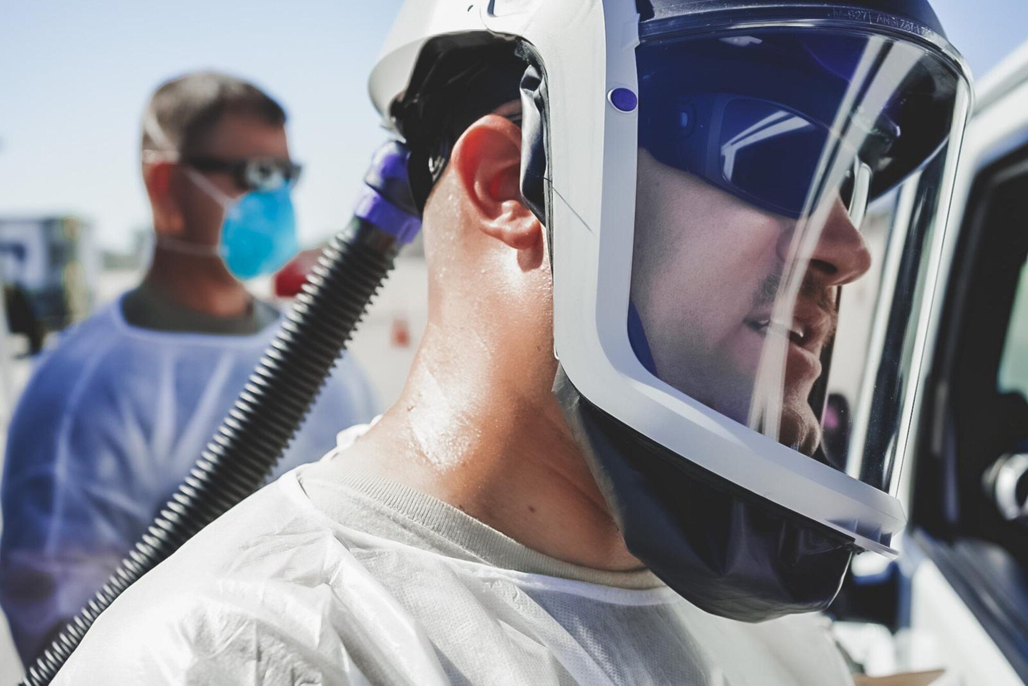 U.S. Air Force Capt. Patrick McGar, 144th Fighter Wing clinical nurse, administers a COVID-19 test at a drive-thru testing site in Indio, Calif.