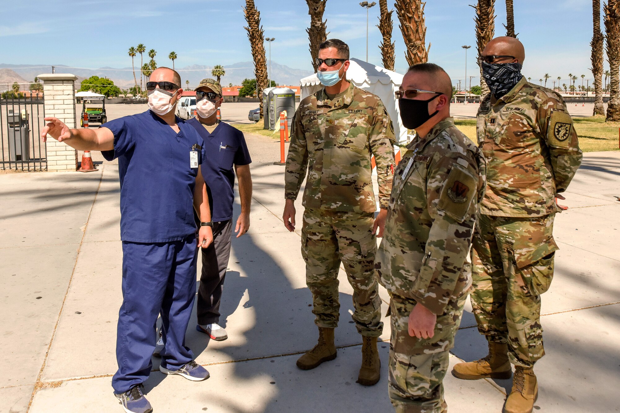 U.S. Air Force Capt. Patrick McGar, a clinical nurse with the 144th Fighter Wing, leads a tour of the Indio, California, COVID-19 testing site, May 7, 2020.