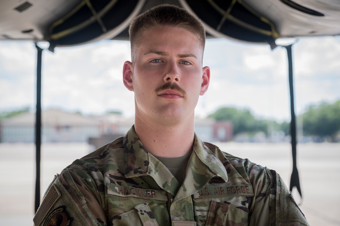 Senior Airman Kaid Hackler, 96th Aircraft Maintenance Unit aerospace propulsion journeyman, poses for a photo below the engines of a B-52H Stratofortress at Barksdale Air Force Base, La., July 23, 2020.