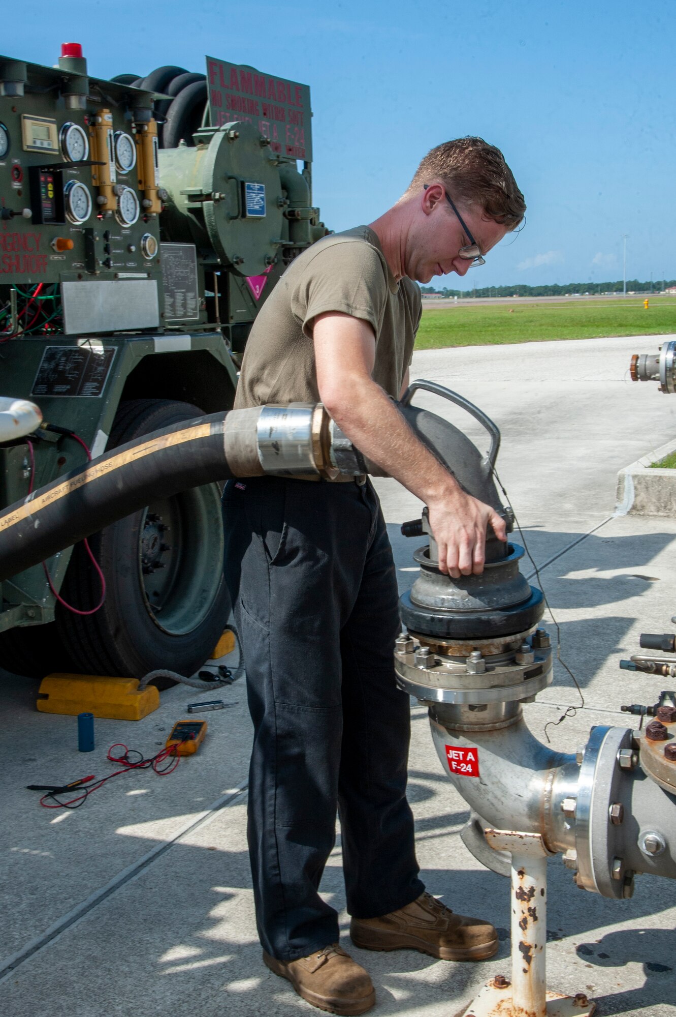 U.S. Air Force Senior Airman Sean Kissel, a 6th Logistics Readiness Squadron firetruck and refueling mechanic connects a nozzle from an R-12 refueling truck to a jet fuel hydrant system, July 15, 2020, at MacDill Air Force Base, Fla.