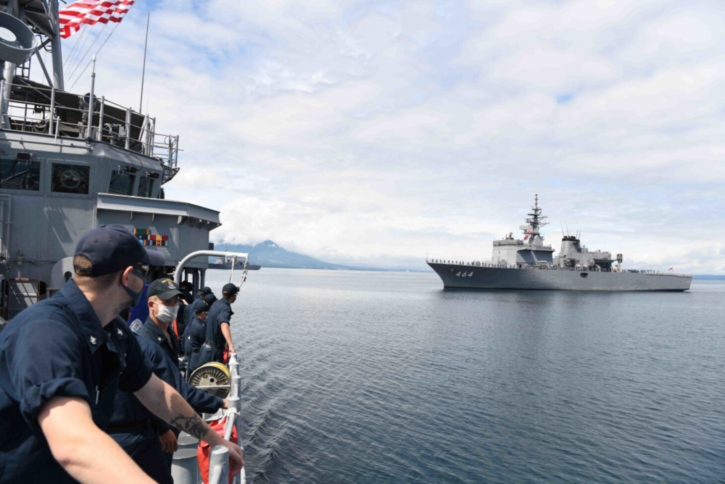 MUTSU BAY (July 23, 2020) – Sailors aboard mine countermeasures ship USS Pioneer (MCM 9) watch as they pass Japan Maritime Self-Defense Force (JMSDF) mine sweeper tenders JS Uraga (MST-463) and JS Bungo (MST-464) upon conclusion of Mine Warfare Exercise (MIWEX) 2JA 2020. MIWEX 2JA is an annual bilateral exercise held between the U.S. Navy and Japan Maritime Self Defense Force (JMSDF) to strengthen interoperability and increase proficiencies in mine countermeasure operations.