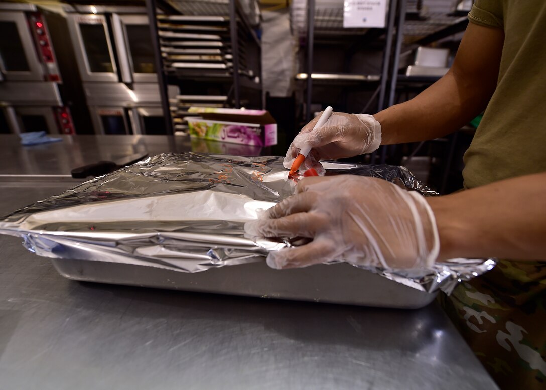 Airmen from the 378th Expeditionary Force Support Squadron services section prepare and serve lunch to base personnel.