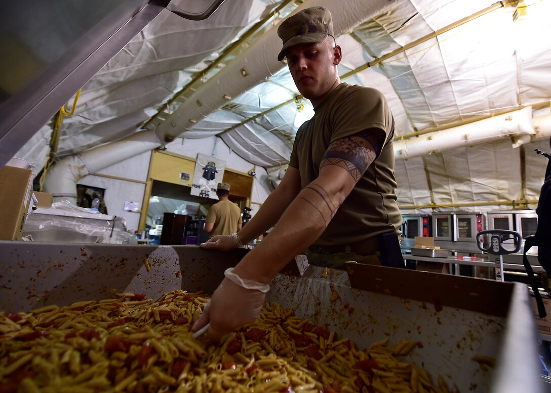 Airmen from the 378th Expeditionary Force Support Squadron services section prepare and serve lunch to base personnel.