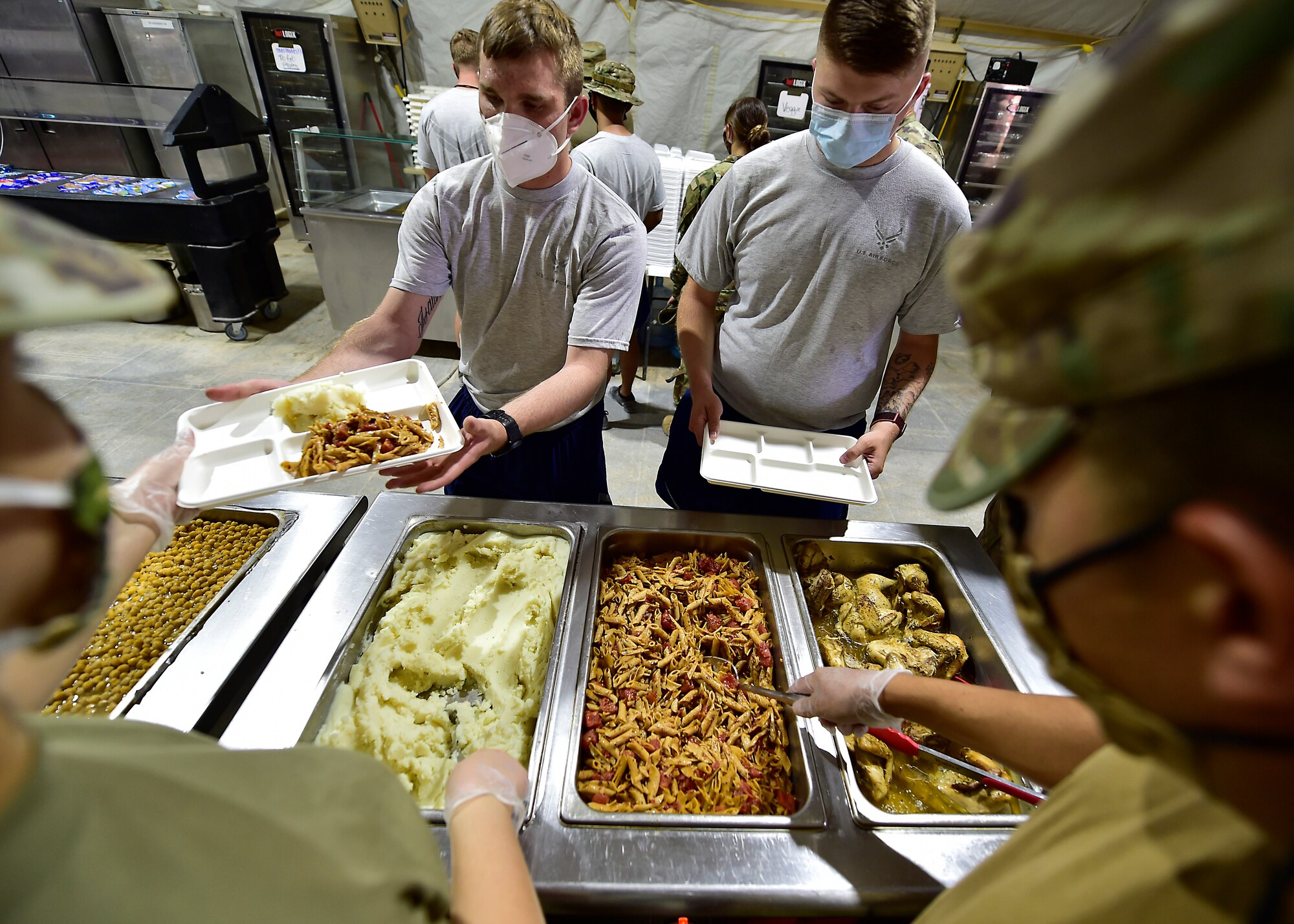 Airmen from the 378th Expeditionary Force Support Squadron services section prepare and serve lunch to base personnel.
