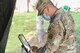 Staff Sgt. Jose Marrero, Massachusetts National Guard mechanic, creates an appointment on a tablet at the Visitor Control Center at Hanscom Air Force Base, Mass., July 29. Personnel can now join the queue and schedule VCC appointments in advance by visiting https://v2.waitwhile.com/welcome/hafbvcc.(U.S. Air Force photo by Todd Maki)