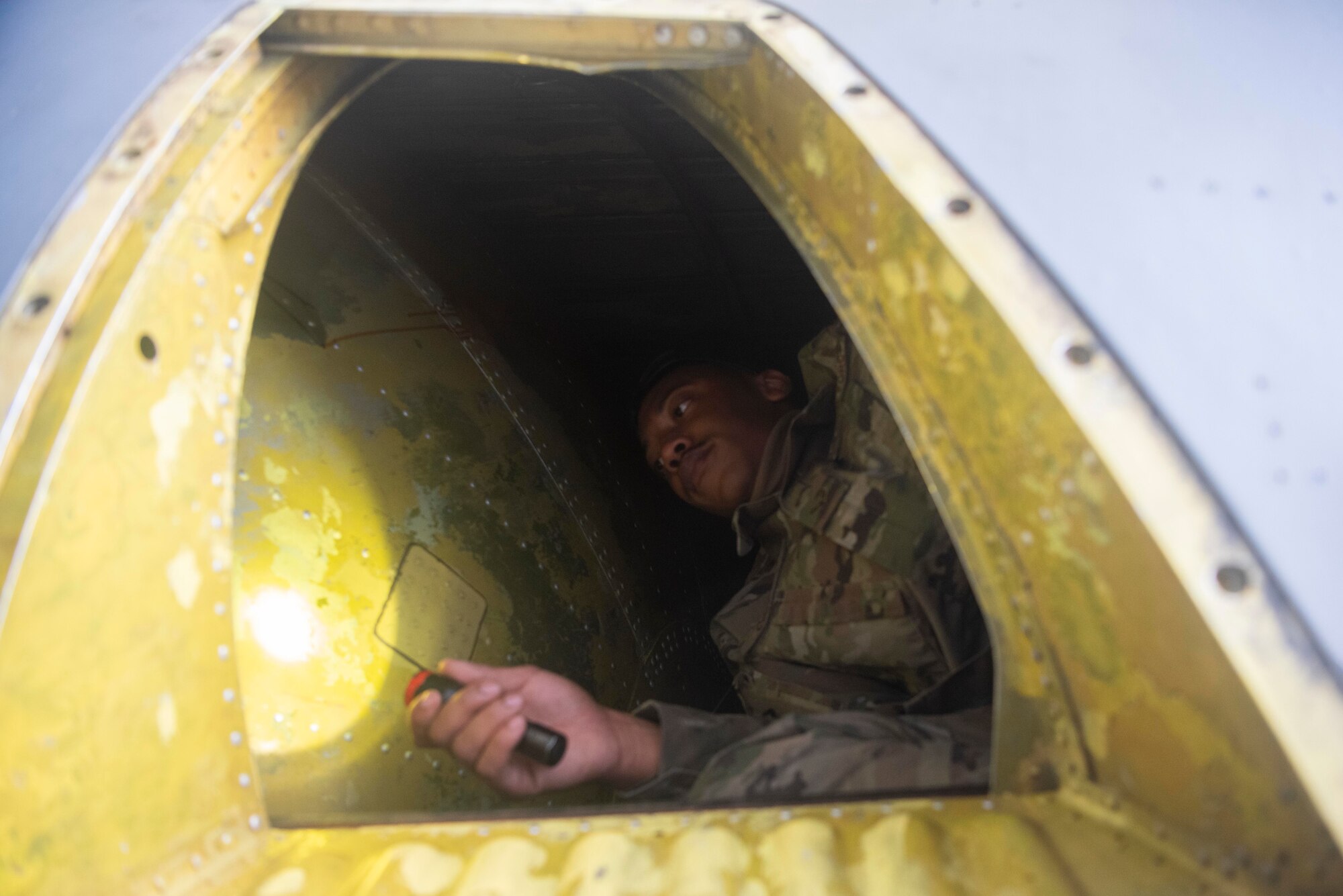 Airman 1st Class Torris Colston, 100th Maintenance Squadron KC-135 Stratotanker crew chief, looks for foreign object debris in the tail compartment of a KC-135 Stratotanker July 28, 2020, at RAF Mildenhall, England. The FOD check improves aircrew safety by confirming unaccounted parts don’t take flight that could impact the operation of the aircraft. (U.S. Air Force photo by Airman 1st Class Joseph Barron)